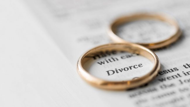 diivorce-rings-closeup-FP Closeup of wedding rings placed on page that reads "divorce" illustrates blog "5 Legal Tips To Prepare for Your Divorce"