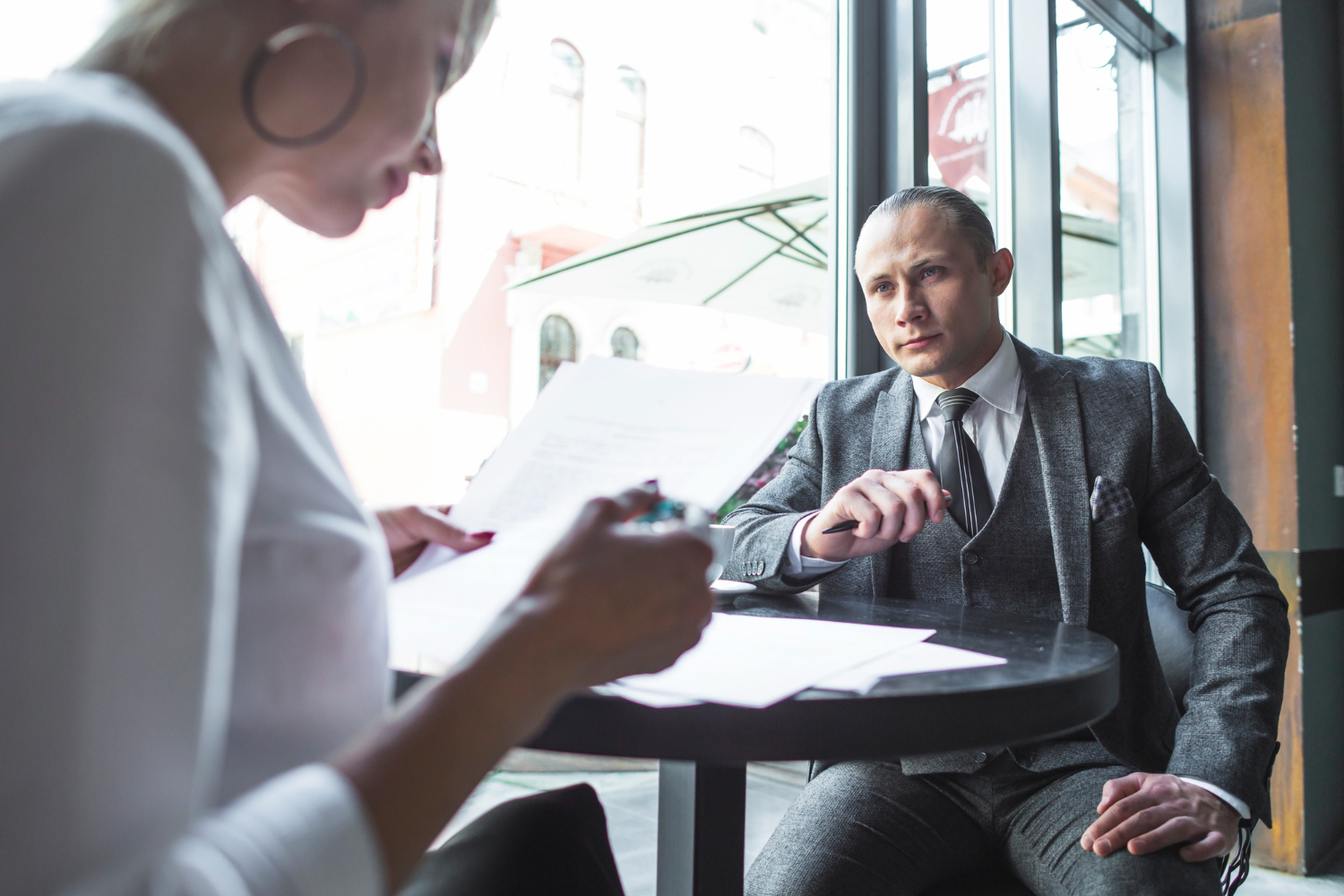 Realistic photo of a person meeting with a criminal defense attorney in a modern California law office, reviewing legal paperwork, calm and hopeful atmosphere, natural daylight