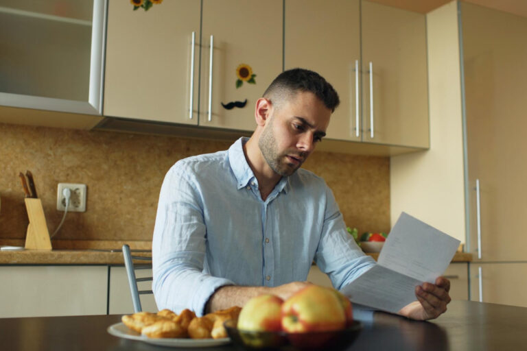 Man reviewing documents showing criminal record consequences affecting employment
