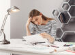person stressed after they miss court date reviewing legal paperwork