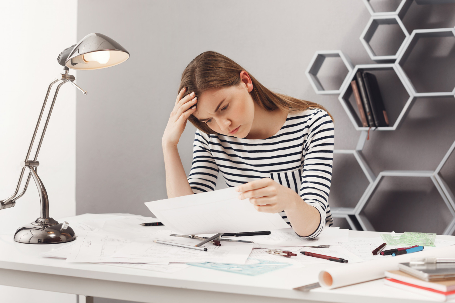 person stressed after they miss court date reviewing legal paperwork
