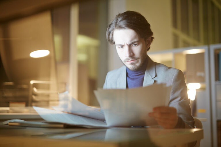 Person reviewing paperwork about the need to address criminal charges early